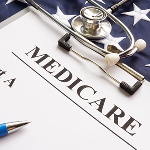 Medicare enrollment form, stethoscope, and American flag representing long-term care planning