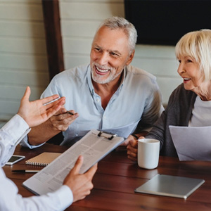 Aging parents discussing estate planning with lawyer in New York.