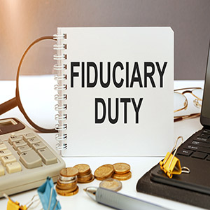 Notebook with Fiduciary Duty text on a desk for New York trustee legal obligation guidance.